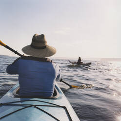 Middle aged man and woman sea kayaking. - MINF15213