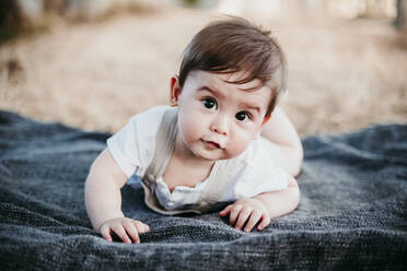Cute baby crawling on blanket outdoors - EBBF00973