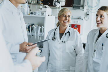 Smiling male and female scientist standing at laboratory - MFF06540