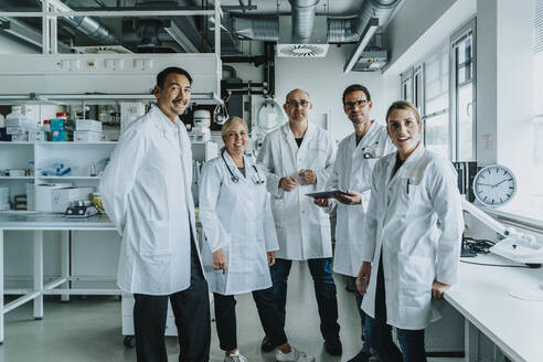 Confident scientist team standing together at laboratory - MFF06549