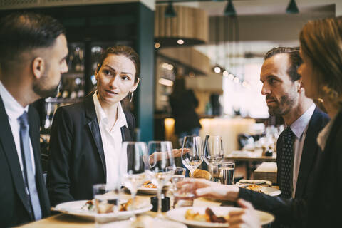 Business coworkers communicating at lunch in restaurant stock photo