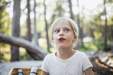 Cute girl looking away while standing in forest - MASF20165