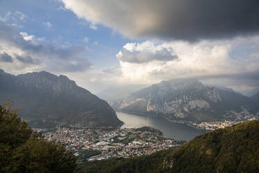 Scenic view of cityscape with Lake Como and mountains against sky at sunset - MCVF00632