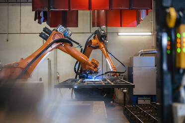 Industrial robotic arms welding in factory - DIGF12932