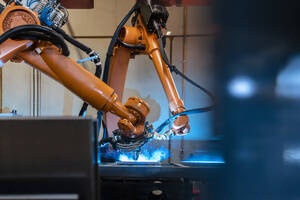 Orange color robotic arms manufacturing in industrial factory - DIGF12934