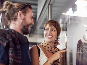 Couple doing window shopping in city - AJOF00391