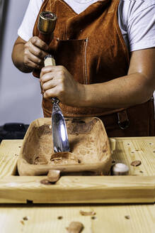 Craftswoman working with Wooden tray - CAVF89793