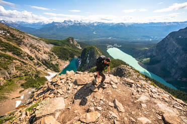 Hiker Climbing Up Devil's Thumb Peak in Lake Louise Banff - CAVF89889