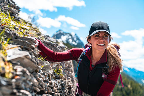 Hiker Balancing Herself Along Mountain Scramble in Kananaskis Country - CAVF89943