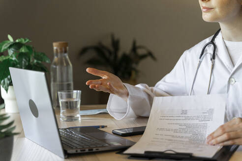 Young female doctor discussing on video call during online consultation - AFVF07381