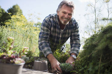 Portrait happy senior man gardening - CAIF29912