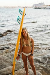 Young surfer female in bikini with orange surf board - CAVF90131