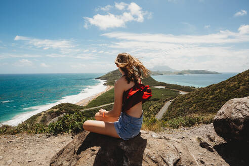 Girl looks out over the Caribbean and Atlantic Ocean stunning views - CAVF90161