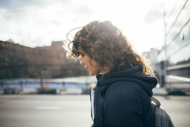 Woman with eyes closed standing by road at city - OYF00229