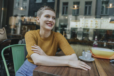 Thoughtful woman looking away while sitting in cafe - MFF06773