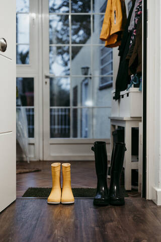 Yellow and black color jump boot on door at home stock photo