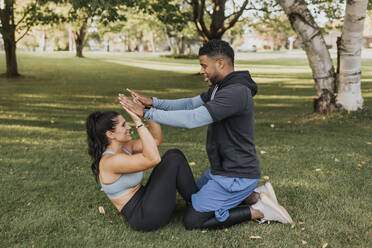 Man and woman giving high five while exercising at backyard - SMSF00411