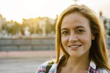 Smiling woman on street during sunny day - XLGF00724