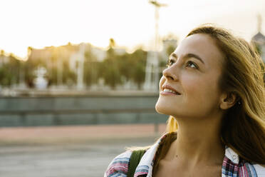 Beautiful blond woman looking up during sunset - XLGF00726