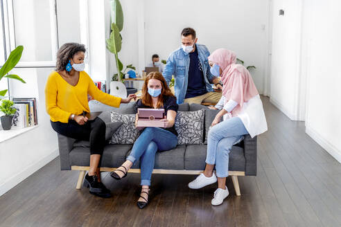 Employees wearing face mask maintaining social distance while working at office during COVID-19 - MPPF01212