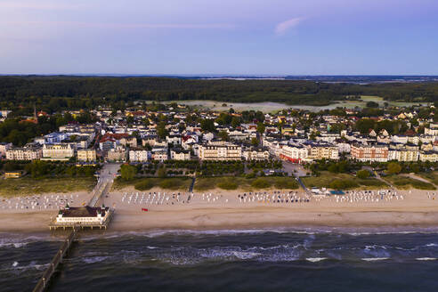 Germany, Mecklenburg-Western Pomerania, Heringsdorf, Aerial view of beach and coastal town at dawn - WDF06367