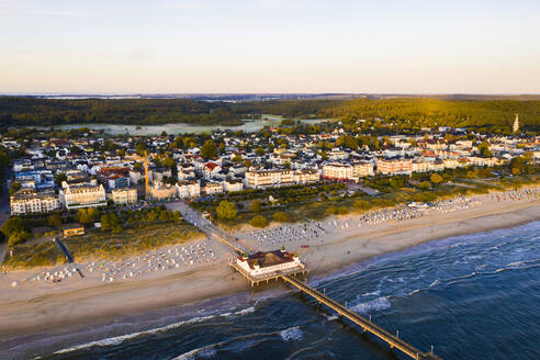 Germany, Mecklenburg-Western Pomerania, Heringsdorf, Aerial view of beach and coastal town at dawn - WDF06368