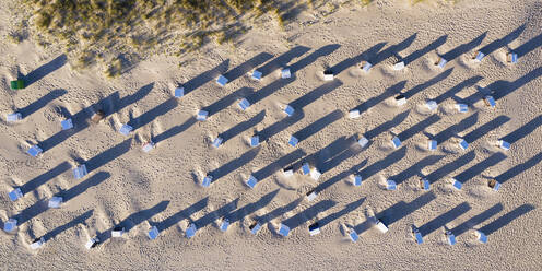 Luftaufnahme von Reihen von Strandkörben mit Kapuze am Sandstrand - WDF06373