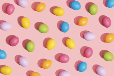 Multi colored easter eggs on pink background - GEMF04348
