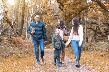 Happy family walking in Cannock Chase park during autumn - WPEF03505