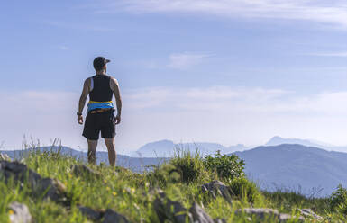 Athlete looking at view while standing on mountain - SNF00757