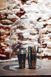 Two metallic cocktail shakers under glass cover - OCMF01835