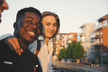 Porträt eines lächelnden Teenagers mit Freund in der Stadt stehend - MASF20711