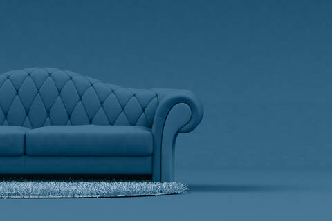 Blue sofa with light blue rug stock photo