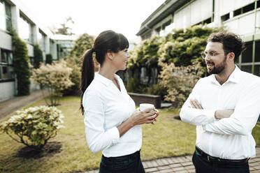 Colleagues talking while taking break at industry - JOSEF02135