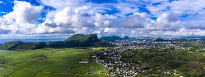 Mauritius, Black River, Flic-en-Flac, Helicopter view of island city with Corps de Garde mountain in background - AMF08666