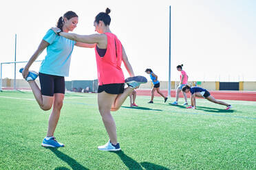 Several young women practice stretching after training - CAVF90265