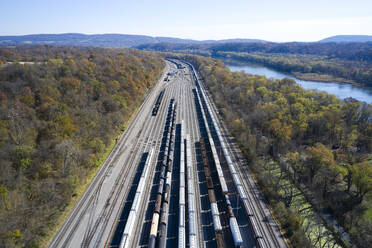 Aerial view of railroad cars waiting on tracks stretching along Chesapeake and Ohio Canal - BCDF00580