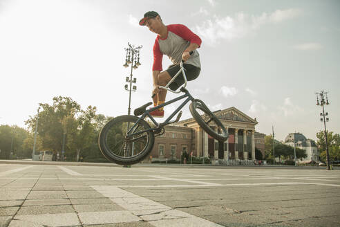 Junger BMX-Biker bei einem Stunt auf dem Heldenplatz, Budapest, Ungarn - AJOF00549