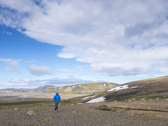 Adventurous man walking on land against sky, Lakagigar, Iceland - LAF02529