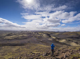Man looking at landscape while standing on rock during sunny day, Lakagigar, Iceland - LAF02532