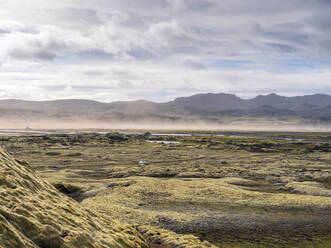 Landscape scenery with sandstorm against cloudy sky, Lakagigar, Iceland - LAF02542