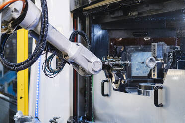 Robotic arm in illuminated factory - DIGF13176