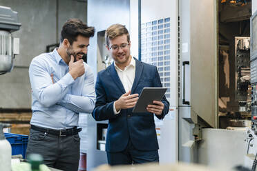 Happy businessmen using digital tablet at industry - DIGF13182