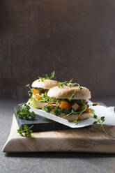 Vegan burger with soy schnitzel strips, bell pepper, radishes, oregano and lettuce - MYF02302