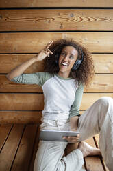 Young woman using digital tablet while sitting at home - PESF02229