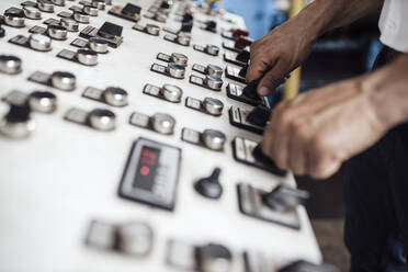 Man's hand on control panel in factory - GUSF04705