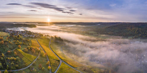 Germany, Baden Wurttemberg, Remstal, Drone view of countryside town at foggy sunrise - STSF02660
