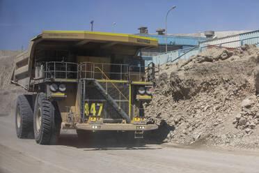 Huge dump trucks working the Chuquicamata open pit copper mine, the largest by volume in the world, Chile, South America - RHPLF18056