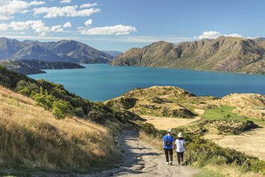 Hiker on Roy's Peak Track enjoying the view over Lake Wanaka, Mount-Aspiring National Park, Otago, South Island, New Zealand, Pacific - RHPLF18127