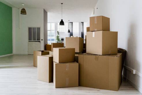 Carboard boxes in living room of new house - GIOF09683